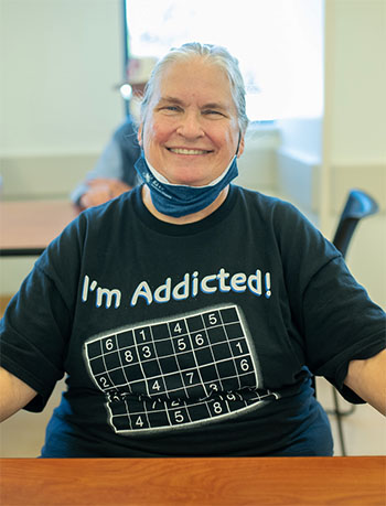 Woman wearing sudoku t-shirt.