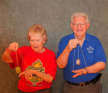 Woman and man playing with yo-yos.