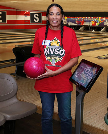 Woman with ten-pin bowling ball.