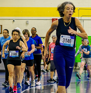Women running in track event.