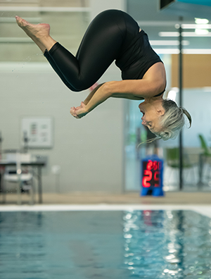 Woman diving into swimming pool.
