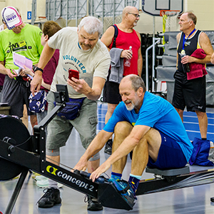 Men participating in the ergonomic rowing event.