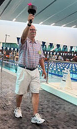 Michael Coleman carries the torch at 2026 NVSO swimming event.