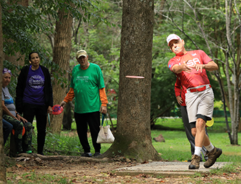 Man playing disc golf.